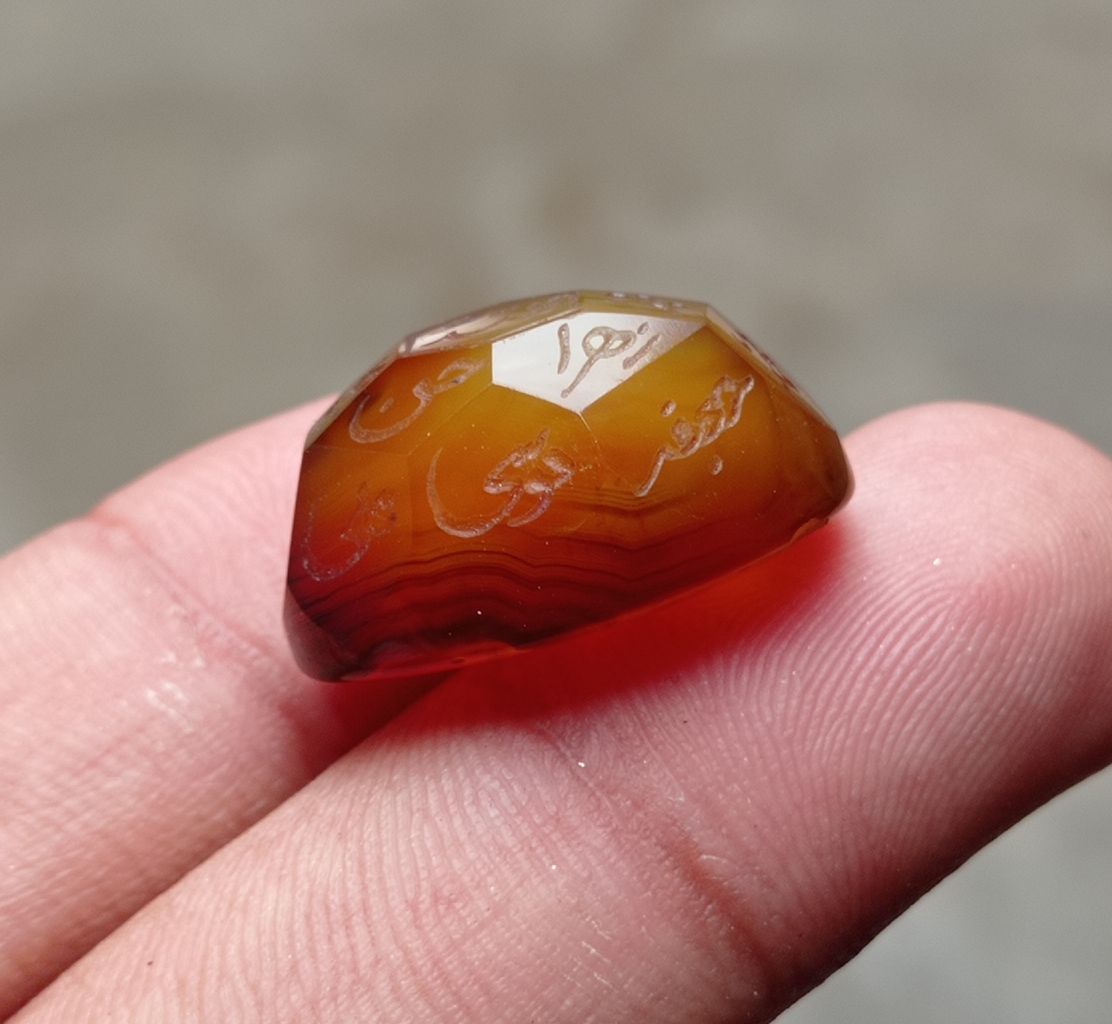 33.9ct Carnelian Carving - Engraved Aqeeq - 12 Imam Name - 23x17mm 33.9ct Carnelian Carving - Engraved Aqeeq - 12 Imam Name - 23x17mm